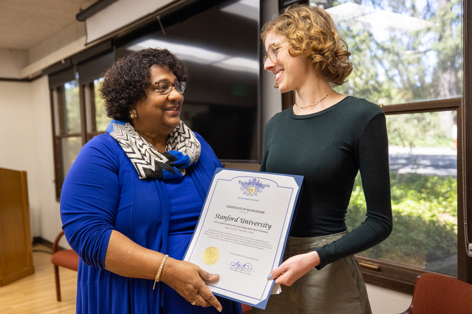 Shirley N. Weber, Ph.D., California Secretary of State (left), presenting the Ballot Bowl certificate to Cameron Lange, a StanfordVotes student leader (right), accepting the award.